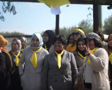 Group of women wearing yellow scarves