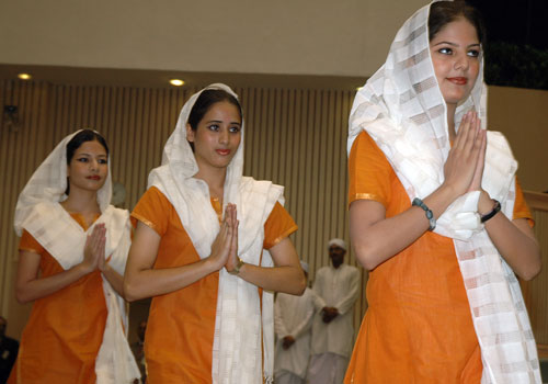 Three women walking in opening ceremony of Fourth International Conference on Federalism in New Delhi